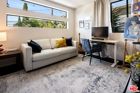 a living room with furniture a rug and a flat screen tv