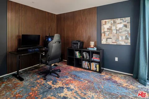 a workspace with furniture bookshelf and a window