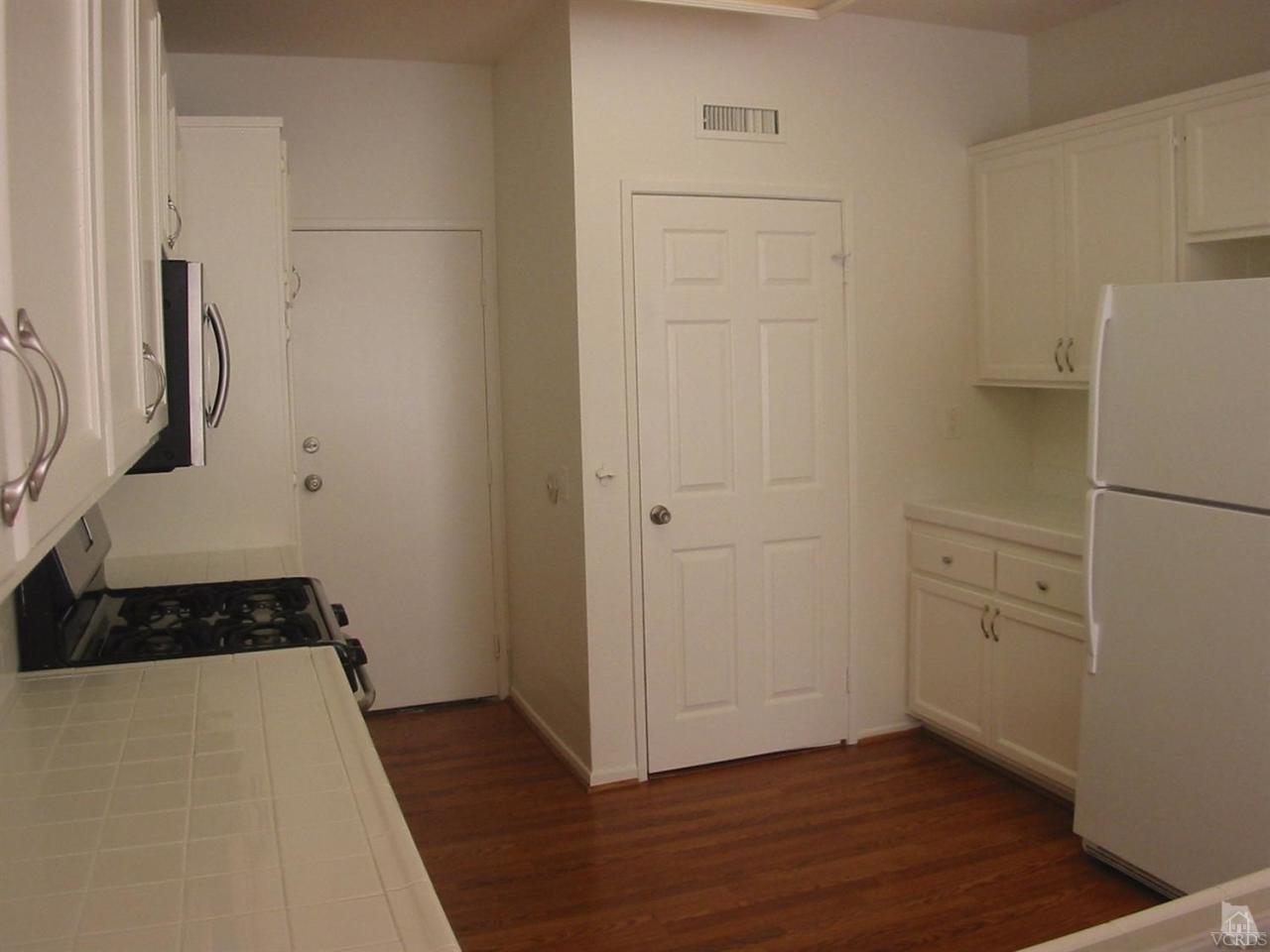 4243 Rusticview Court Moorpark, CA 93021 - Photo 3 of 16 a view of walk in closet with wooden floor