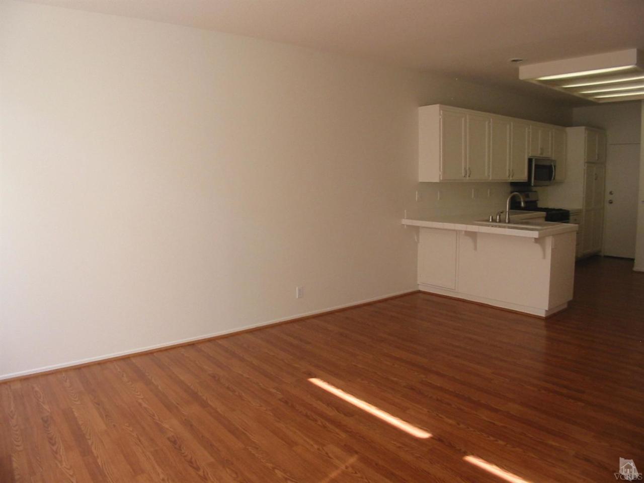 4243 Rusticview Court Moorpark, CA 93021 - Photo 7 of 16 a view of a kitchen with wooden floor and electronic appliances