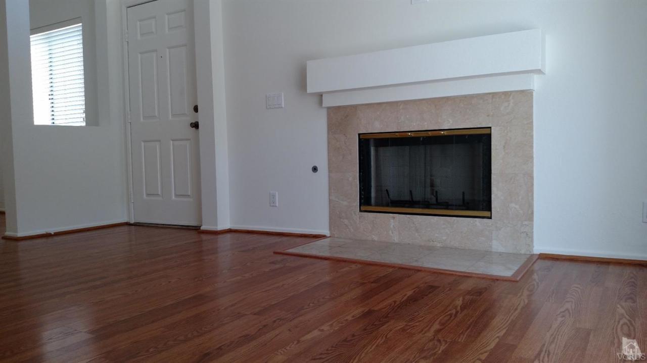 4243 Rusticview Court Moorpark, CA 93021 - Photo 9 of 16 an empty room with wooden floor and windows