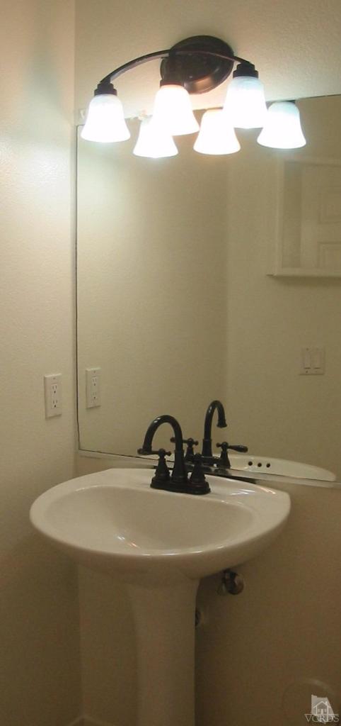 4243 Rusticview Court Moorpark, CA 93021 - Photo 10 of 16 a bathroom with a sink and a mirror