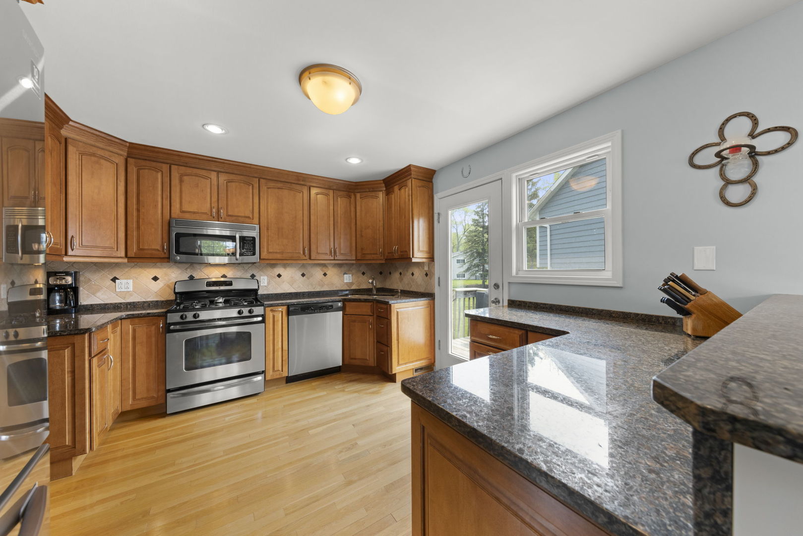 1635 South Prospect Street Wheaton, IL 60189 - Photo 11 of 53 a kitchen with stainless steel appliances granite countertop a stove top oven a sink a counter space and cabinets