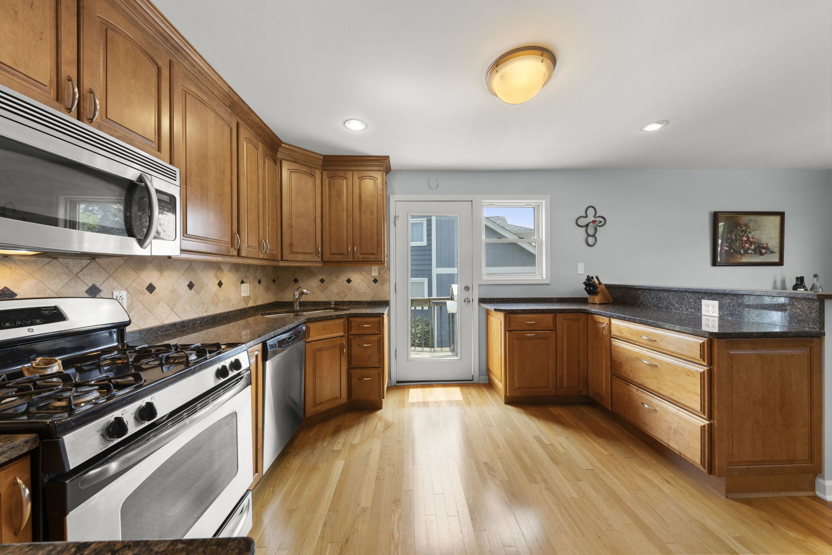 1635 South Prospect Street Wheaton, IL 60189 - Photo 12 of 53 a large kitchen with stainless steel appliances granite countertop a stove and a sink
