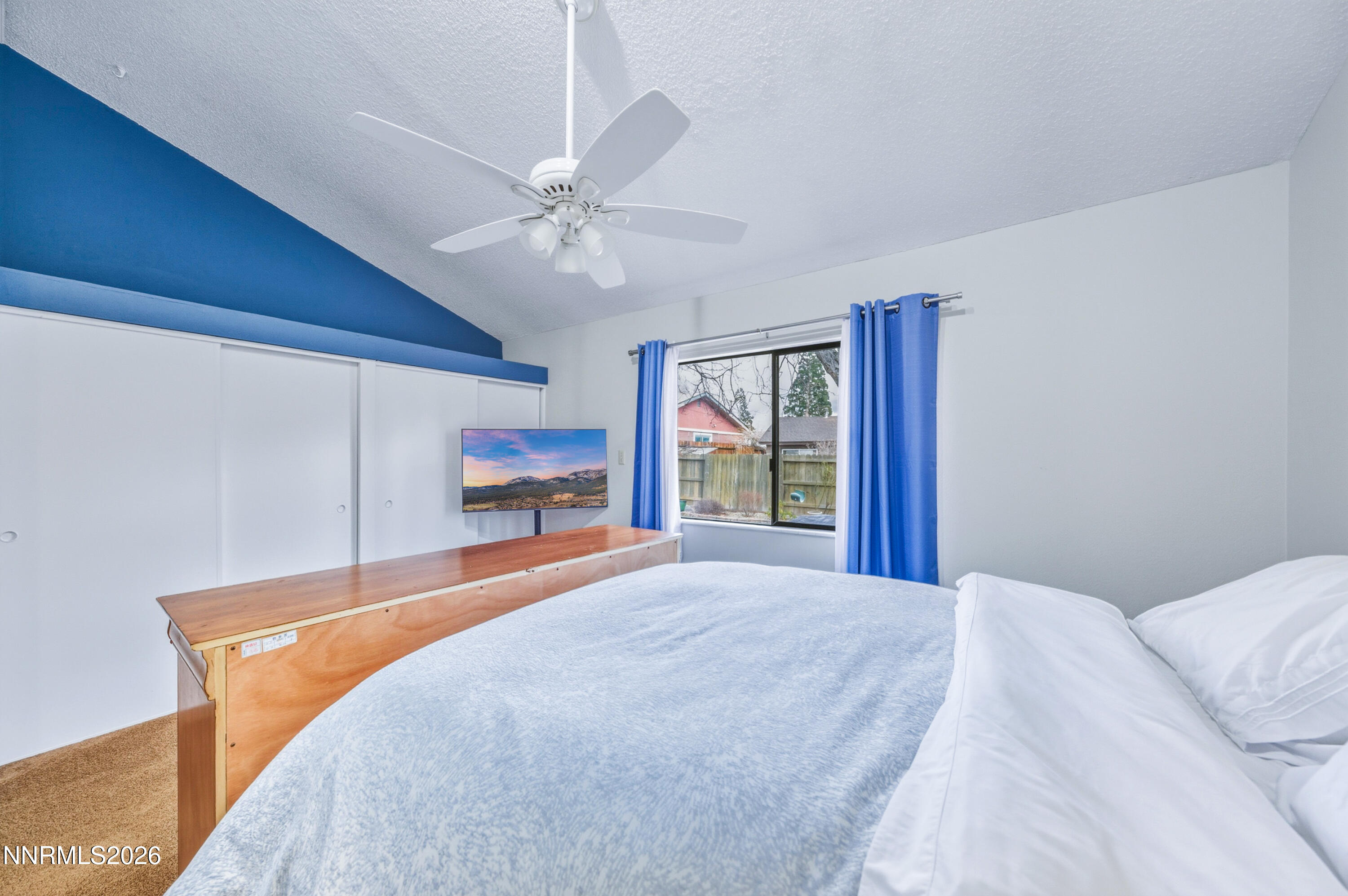 1540 O Farrell Street Reno, NV 89503 - Photo 20 of 41 a bedroom with a large bed and a chandelier