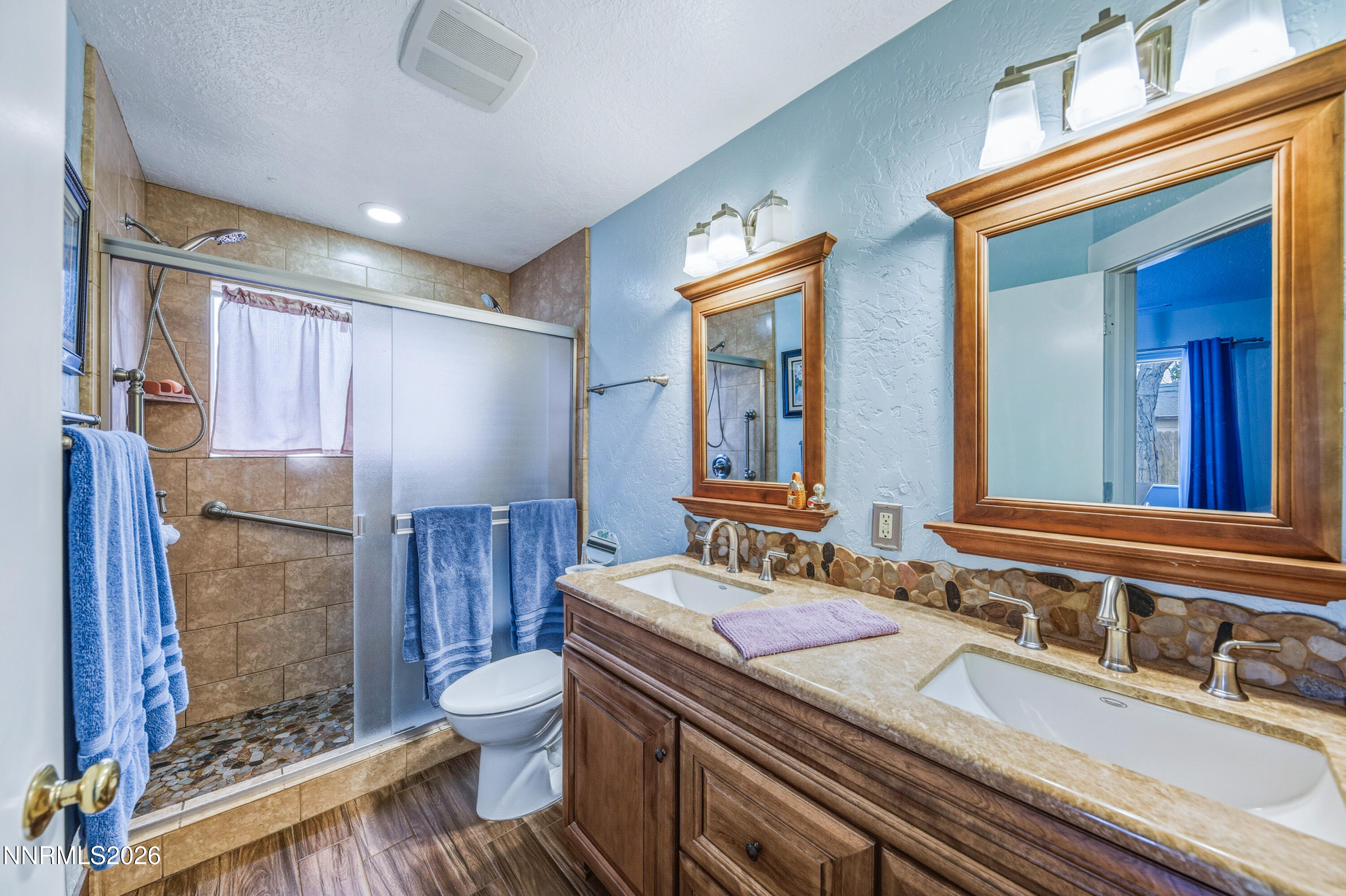 1540 O Farrell Street Reno, NV 89503 - Photo 22 of 41 a bathroom with a granite countertop sink a toilet a mirror and shower