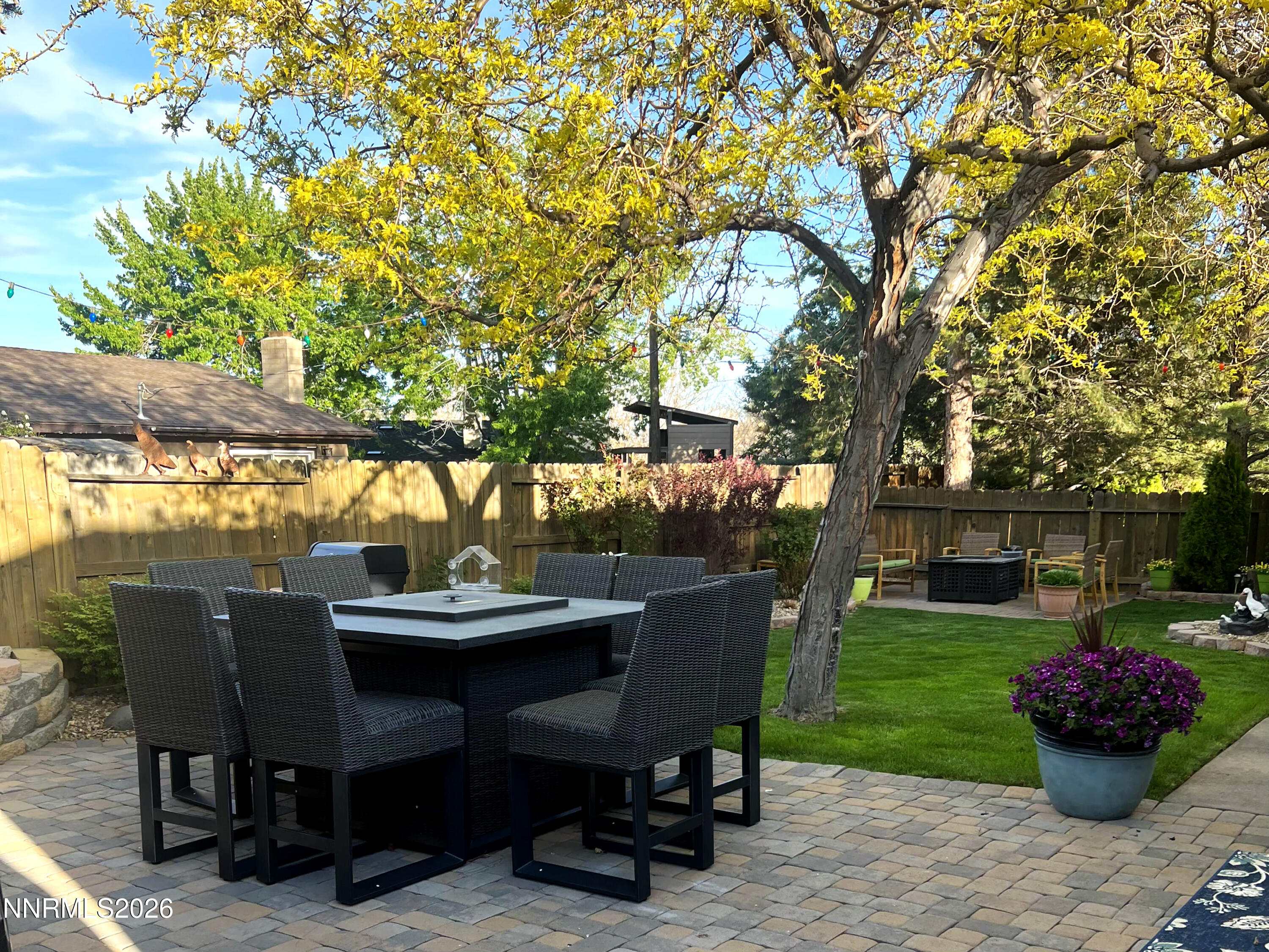 1540 O Farrell Street Reno, NV 89503 - Photo 25 of 41 a view of a patio with table and chairs potted plants and large tree