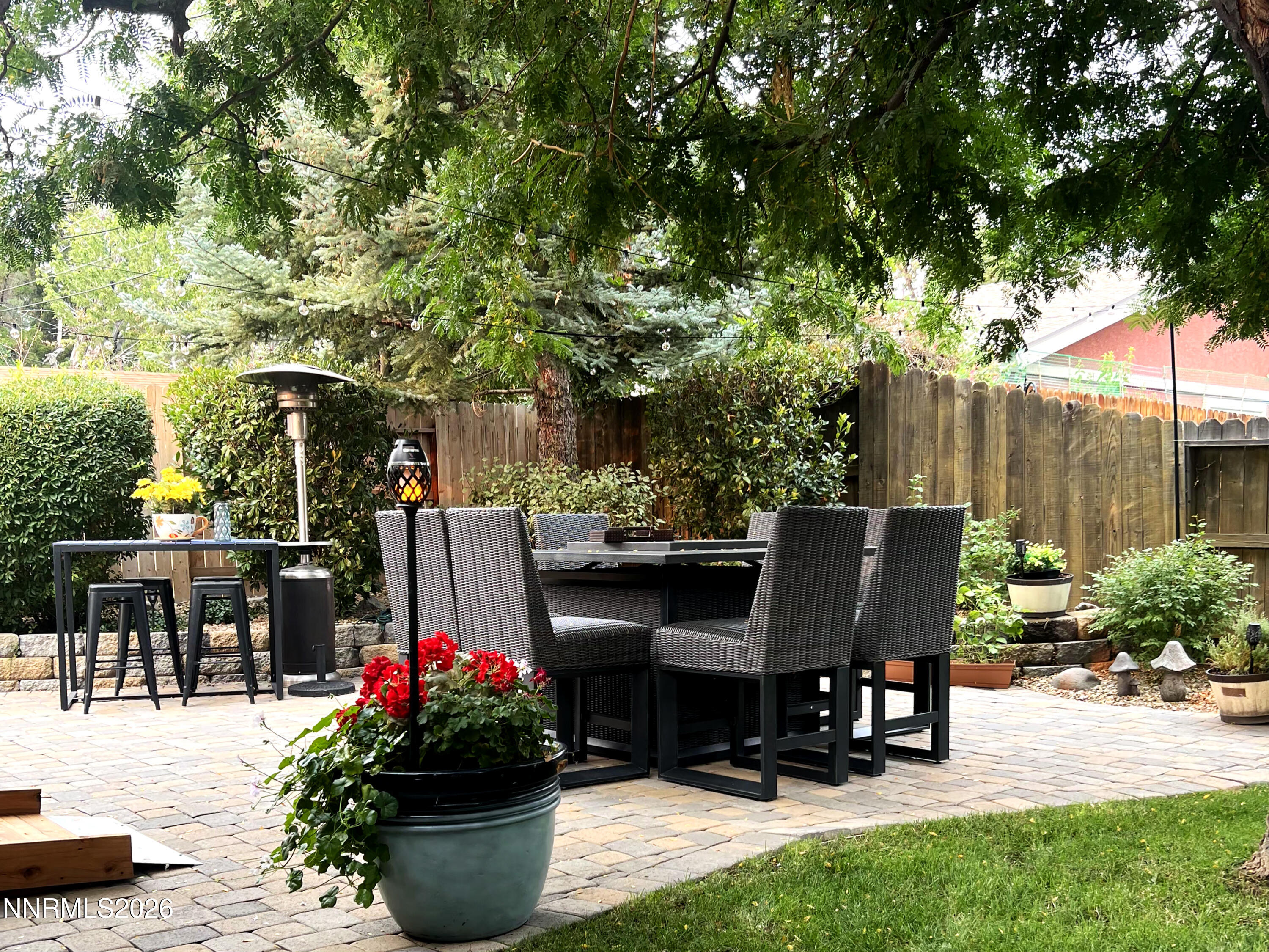 1540 O Farrell Street Reno, NV 89503 - Photo 27 of 41 a view of a patio with table and chairs potted plants and large tree