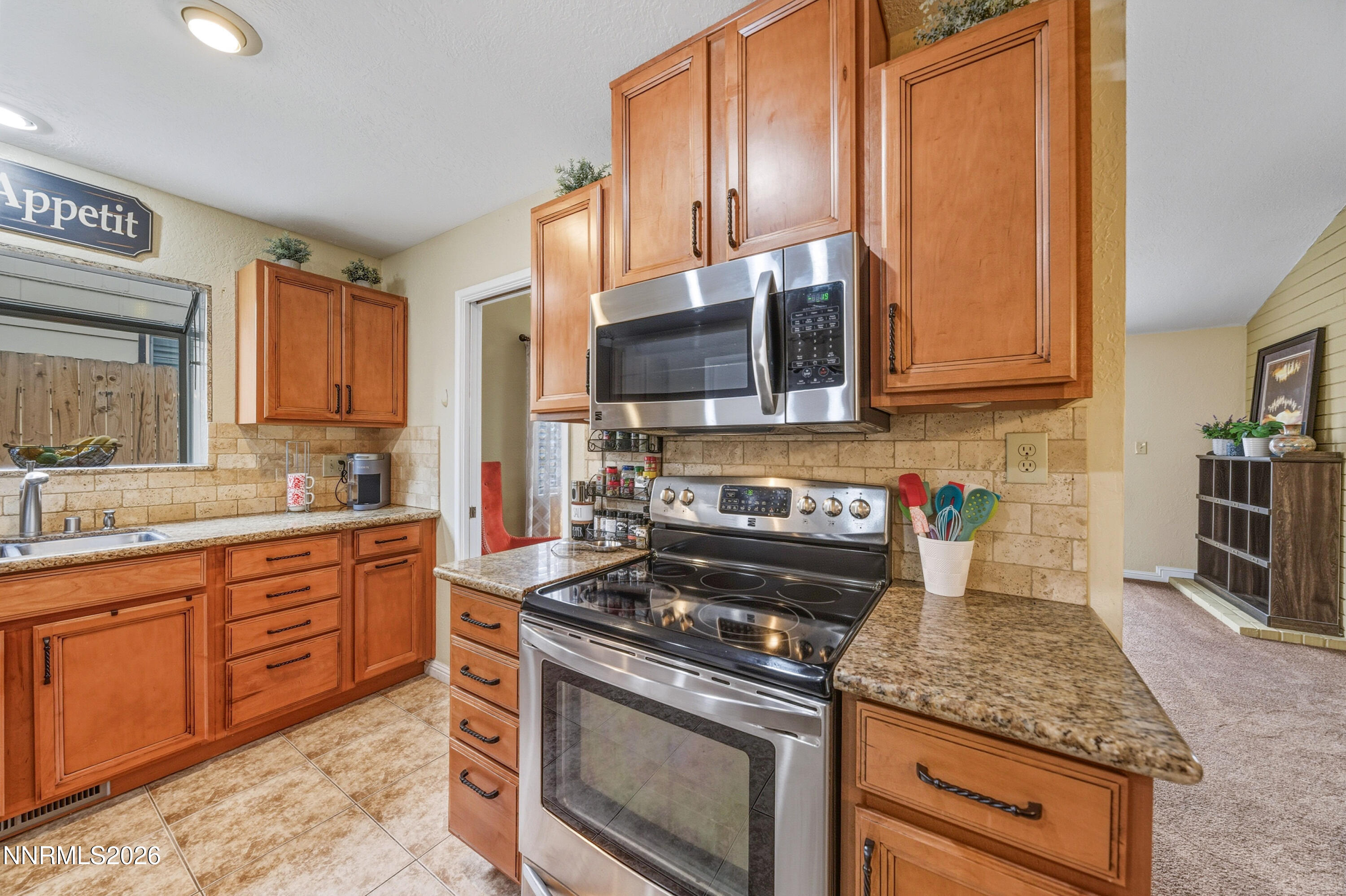 1540 O Farrell Street Reno, NV 89503 - Photo 8 of 41 a kitchen with stainless steel appliances granite countertop a stove microwave and cabinets