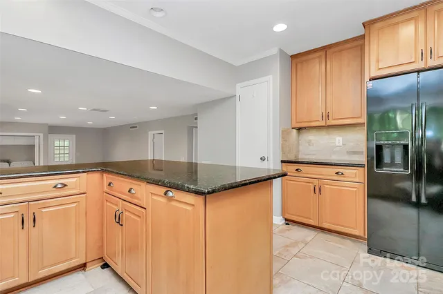 a kitchen with granite countertop a sink stainless steel appliances and cabinets