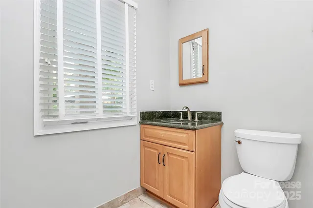 a white toilet sitting next to a window