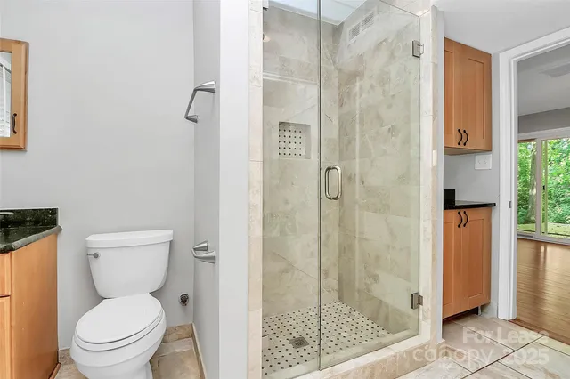a a bathroom with a toilet and a shower