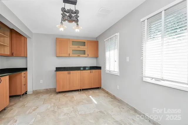 a view of kitchen with granite countertop cabinets and outdoor space