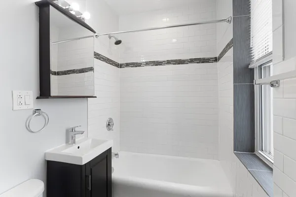 a bathroom with a shower curtain and a sink