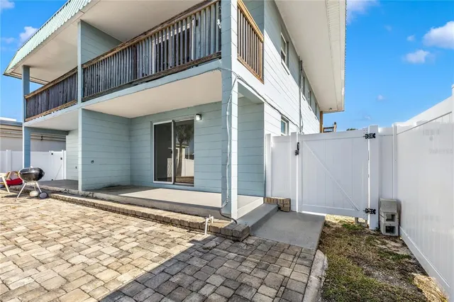 a view of a house with large trees and refrigerator