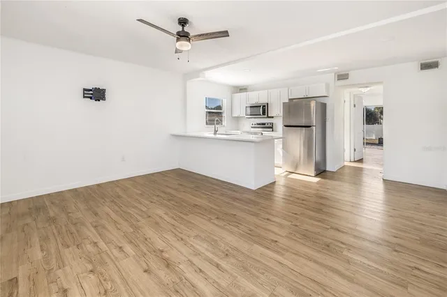 a view of kitchen with stainless steel appliances a refrigerator and a stove top oven
