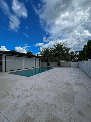 a living room with furniture a flat screen tv and a table