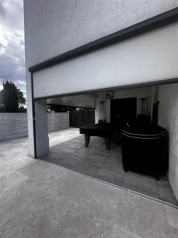 a kitchen with stainless steel appliances granite countertop a table and chairs in it