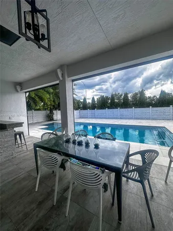 a spacious bedroom with a bed and a chandelier