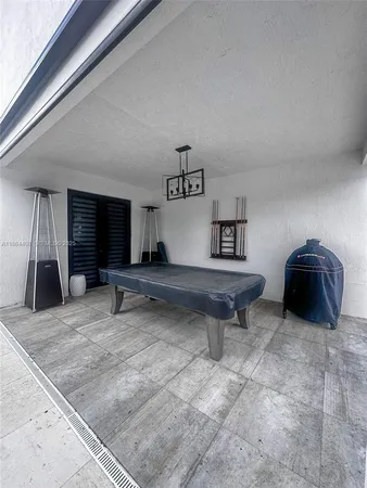 a bedroom with a bed window and a chandelier