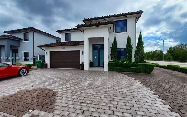 a view of a car parked in front of a house