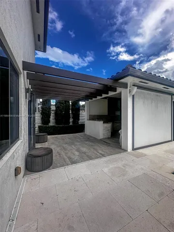 a kitchen with stainless steel appliances kitchen island granite countertop a stove a sink and a refrigerator