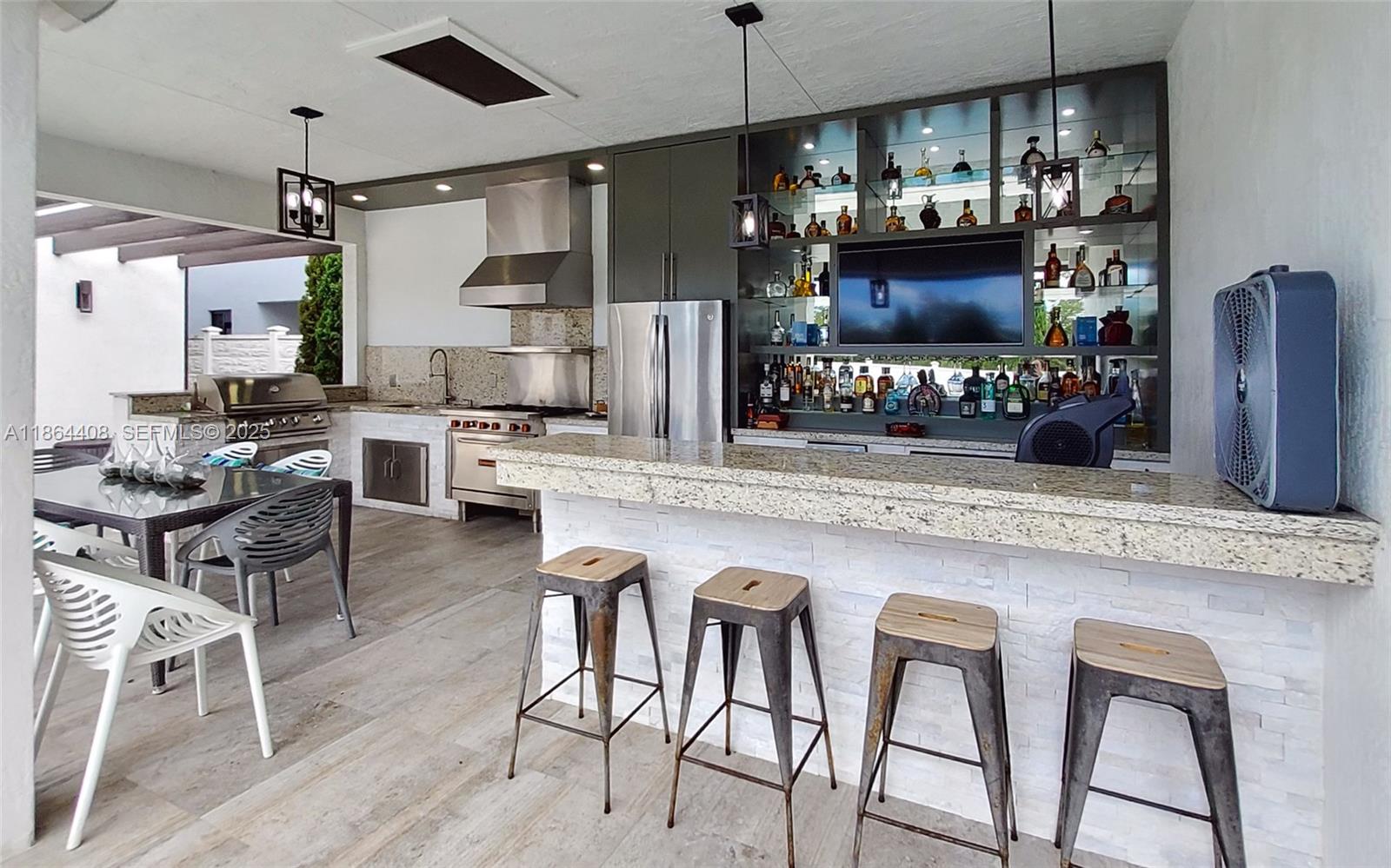 14680 Southwest 17th Street Miami, FL 33175 - Photo 22 of 68 a kitchen with stainless steel appliances granite countertop a table and chairs in it