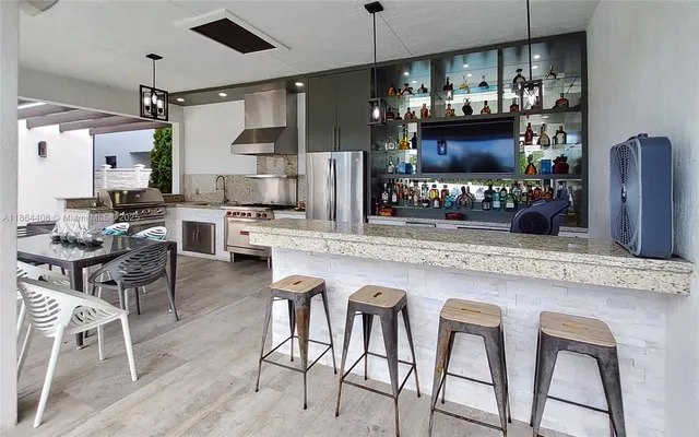a living room with furniture a chandelier and a dining table