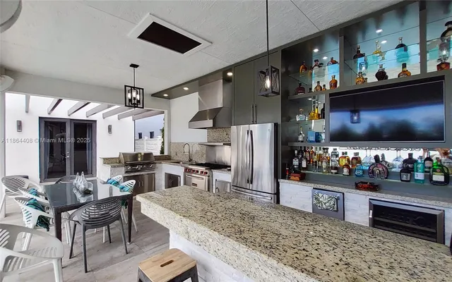 a kitchen with kitchen island a counter top and stainless steel appliances