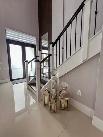 a view of kitchen island dining room wooden floor furniture and a chandelier