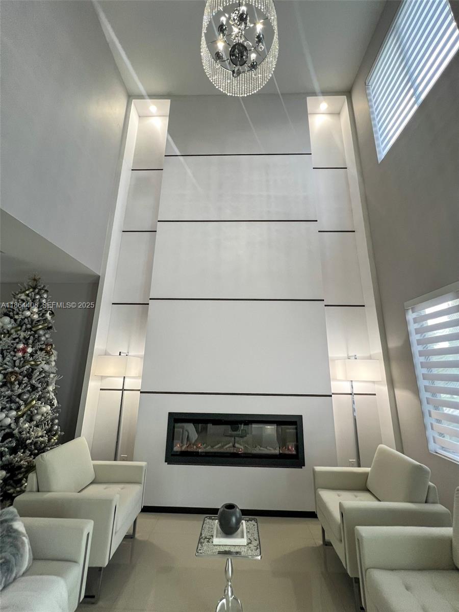14680 Southwest 17th Street Miami, FL 33175 - Photo 27 of 68 a living room with furniture and a chandelier