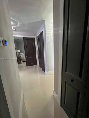 a living room with furniture a fireplace and a chandelier