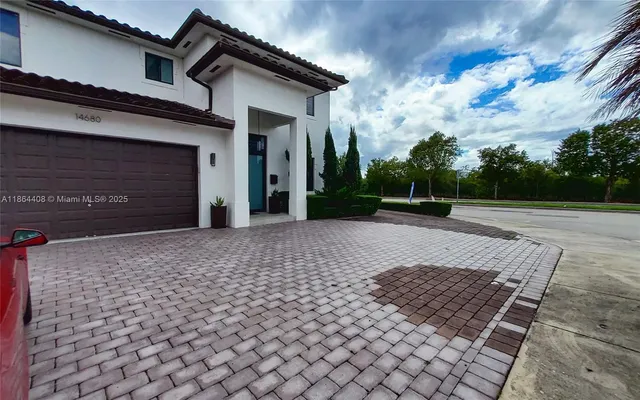 a front view of a house with garden