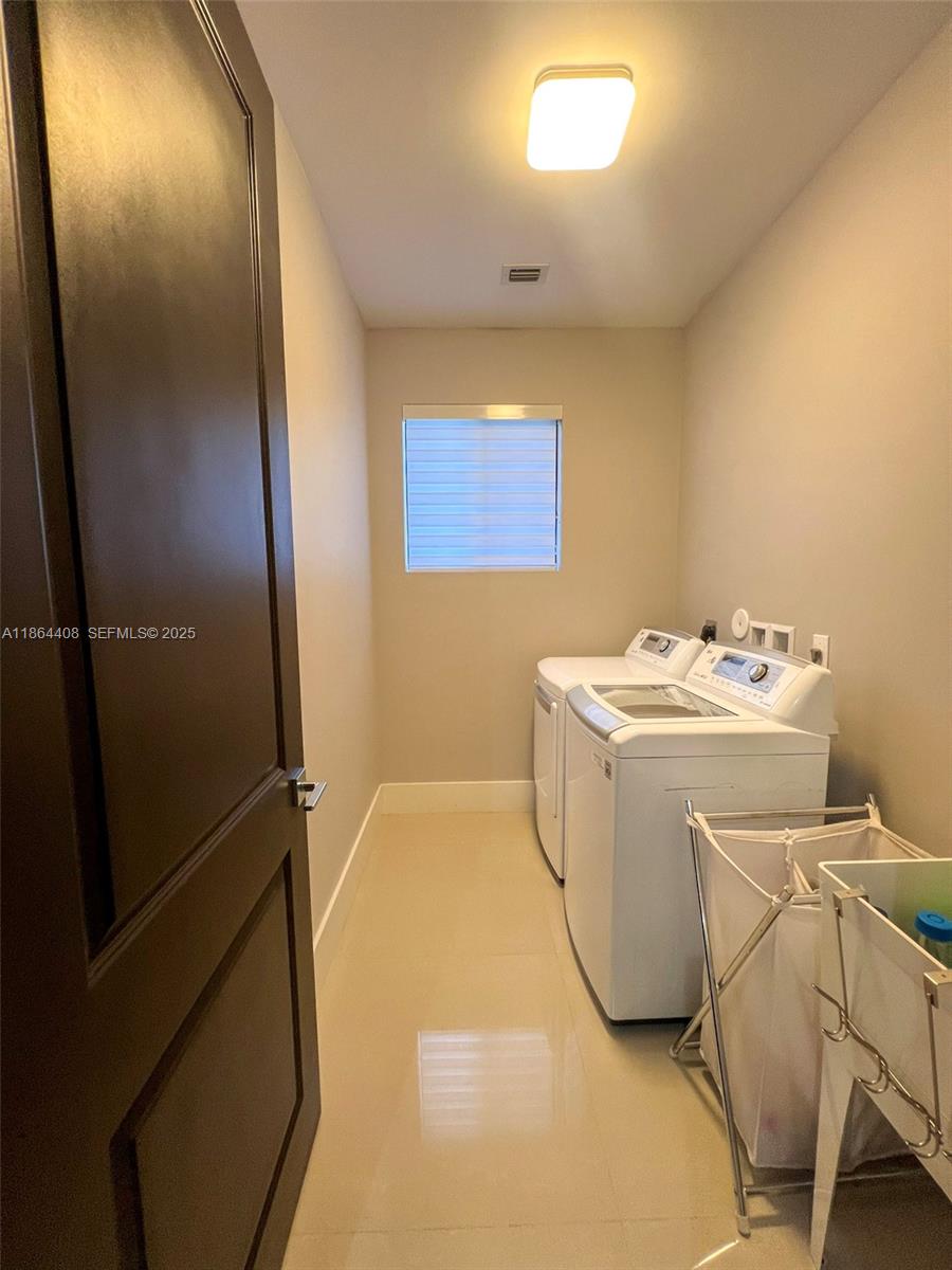 14680 Southwest 17th Street Miami, FL 33175 - Photo 43 of 68 a utility room with washer and dryer