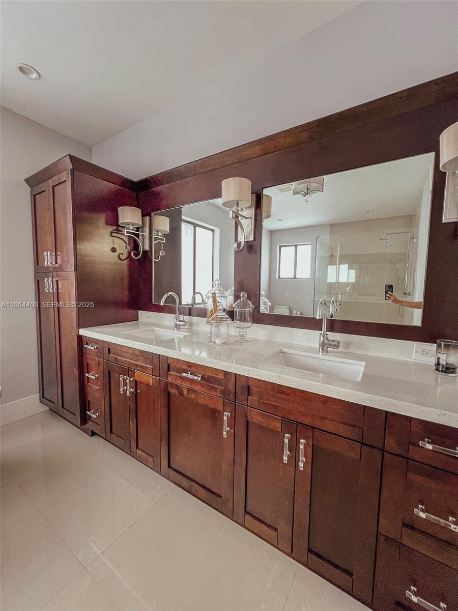 14680 Southwest 17th Street Miami, FL 33175 - Photo 52 of 68 a spacious bathroom with a granite countertop sink and a mirror