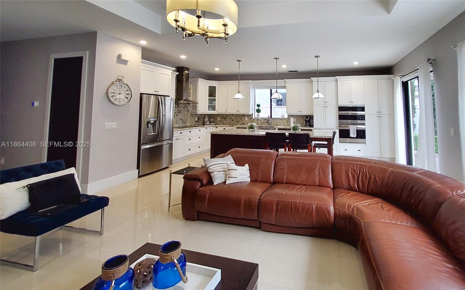 14680 Southwest 17th Street Miami, FL 33175 - Photo 58 of 68 a living room with furniture kitchen and a chandelier