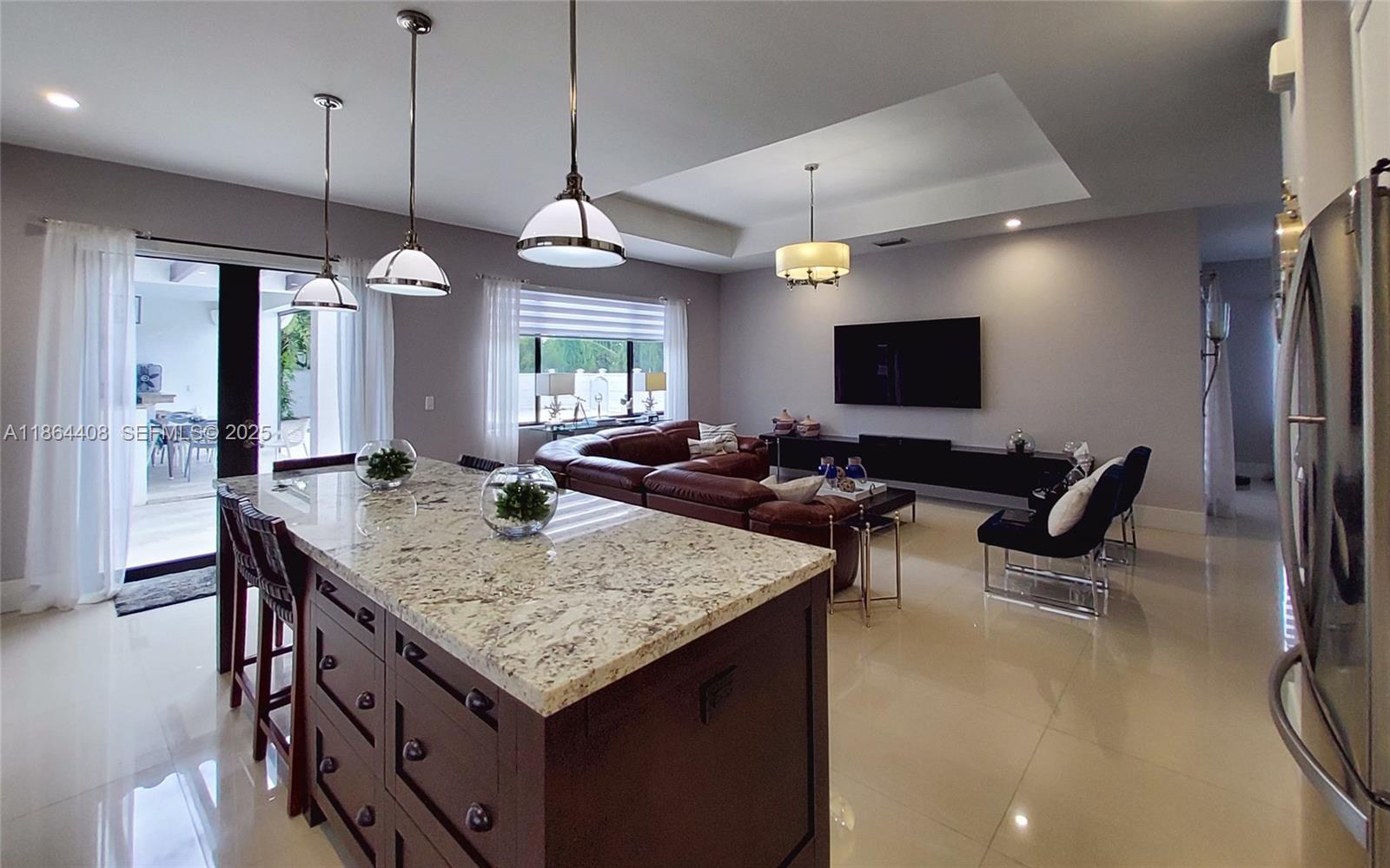 14680 Southwest 17th Street Miami, FL 33175 - Photo 59 of 68 a view of kitchen island dining room wooden floor furniture and a chandelier
