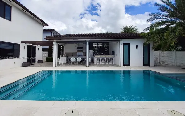a view of swimming pool with outdoor seating