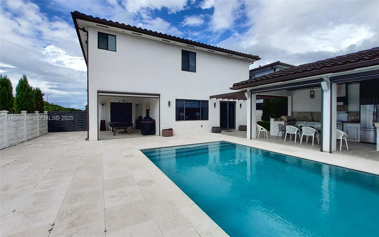 14680 Southwest 17th Street Miami, FL 33175 - Photo 8 of 68 a view of a patio with table and chairs with wooden floor to ceiling windows