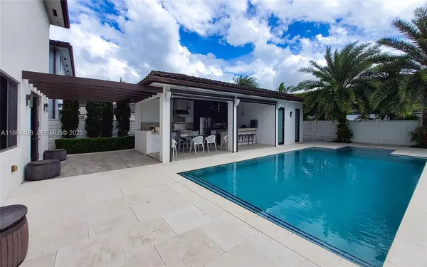 a living room with furniture a flat screen tv and a table