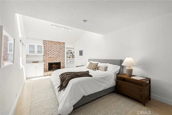 a bedroom with a bed and a fireplace
