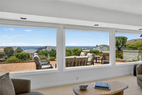 a living room with large window and a table