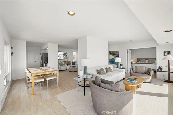 a living room with furniture and view of kitchen