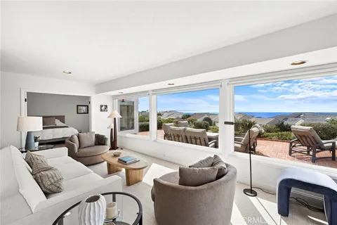 a living room with furniture and view of kitchen