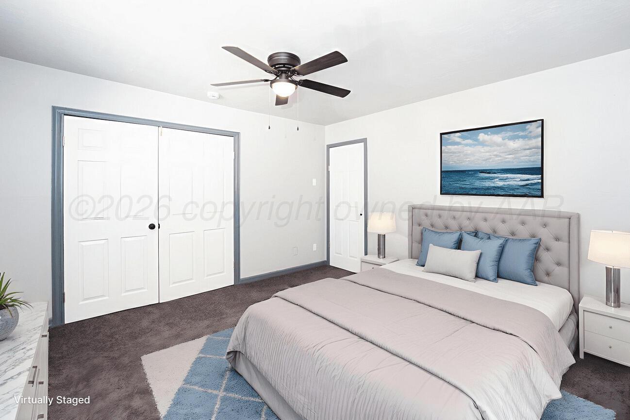 4224 South Polk Street Amarillo, TX 79110 - Photo 17 of 55 a bedroom with a large bed and a chandelier