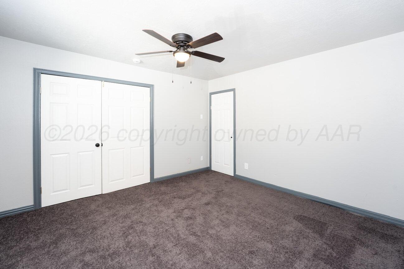 4224 South Polk Street Amarillo, TX 79110 - Photo 18 of 55 an empty room with a ceiling fan and window