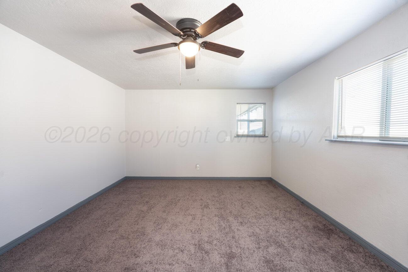 4224 South Polk Street Amarillo, TX 79110 - Photo 20 of 55 an empty room with windows and fan