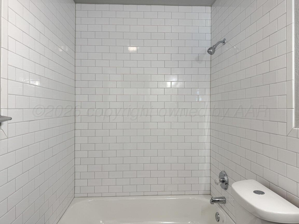 4224 South Polk Street Amarillo, TX 79110 - Photo 23 of 55 a bathroom with a toilet and a bathtub