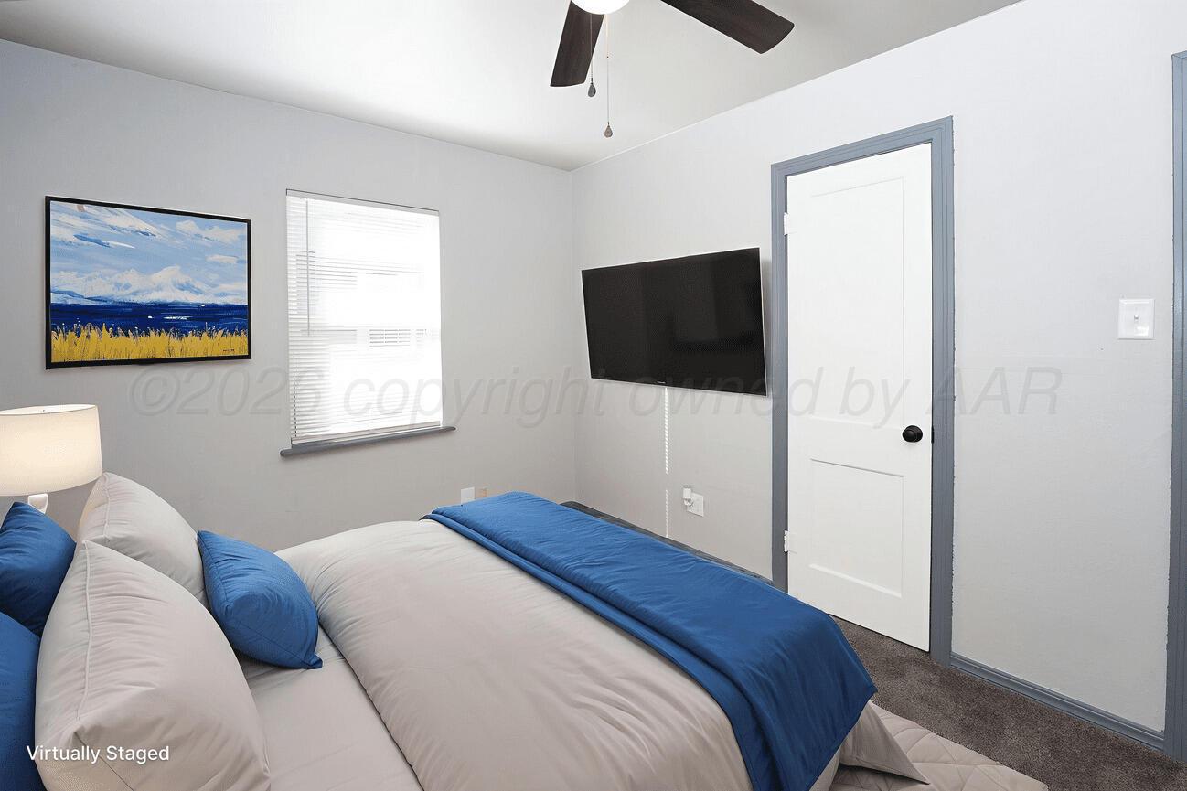 4224 South Polk Street Amarillo, TX 79110 - Photo 25 of 55 a bedroom with a bed and a flat screen tv