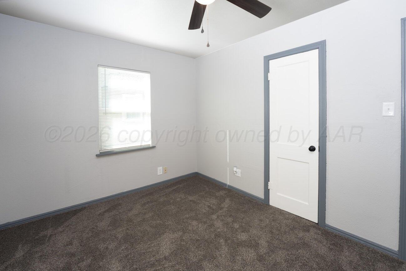 4224 South Polk Street Amarillo, TX 79110 - Photo 26 of 55 an empty room with windows and ceiling fan